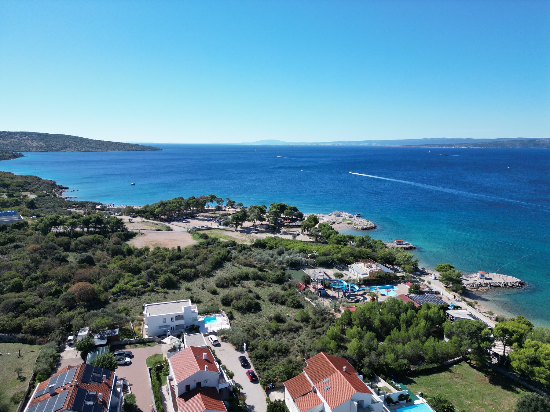 View of the coast, beach and nearby houses in Punat